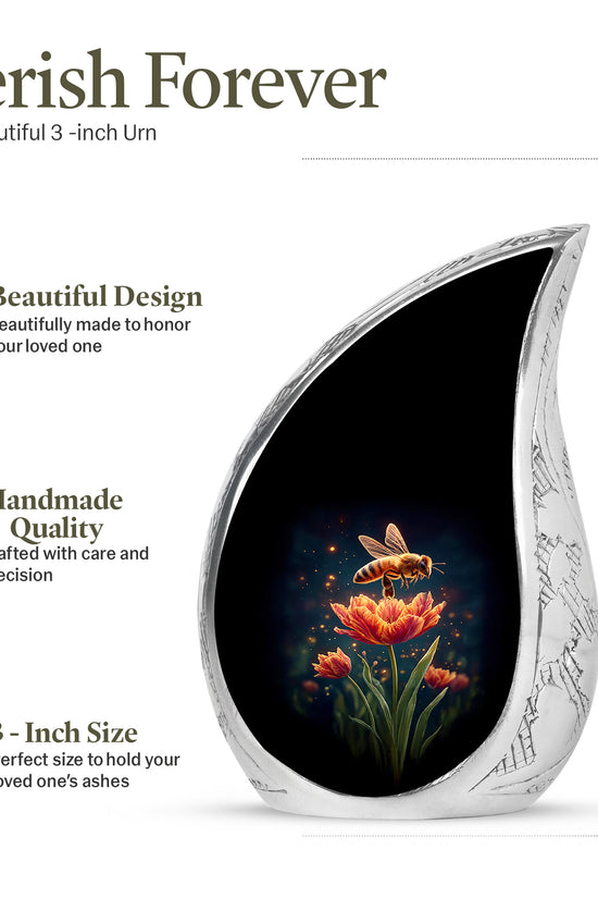 Jet Black Bee Cremation Urn angled view of lid and engraved motif - flowing teardrop bee silhouette on curved aluminum - mini keepsake memorial for portion of cremation ashes