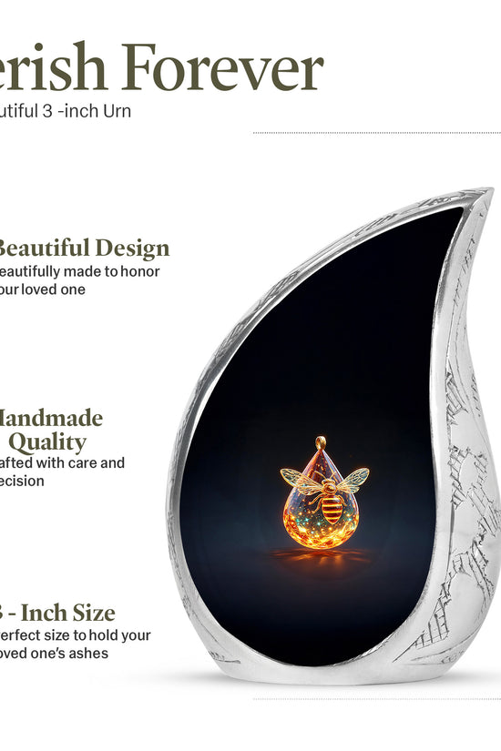 Deep Black Bee Cremation Urn angled view of lid and engraved motif - rounded teardrop bee design with delicate detail - mini keepsake memorial for portion of cremation ashes