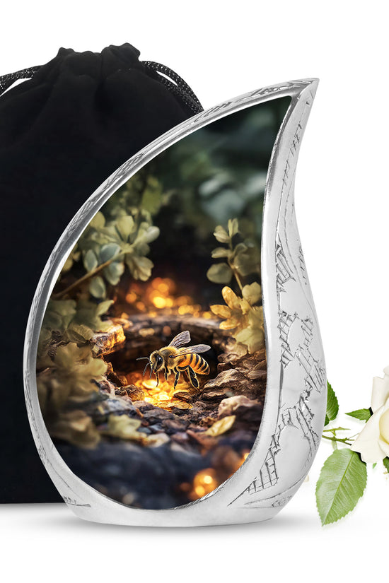 Amber Gold Bee Cremation Urn front view showing detailed design - flowing teardrop bee silhouette on curved aluminum - full-size 10 inch 200 cubic inch adult cremation urn