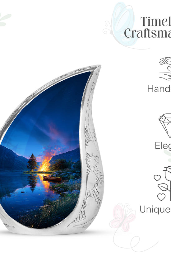 Cornflower Blue Campfire Cremation Urn angled view of lid and engraved motif - smooth teardrop contour featuring campfire art - mini keepsake memorial for portion of cremation ashes