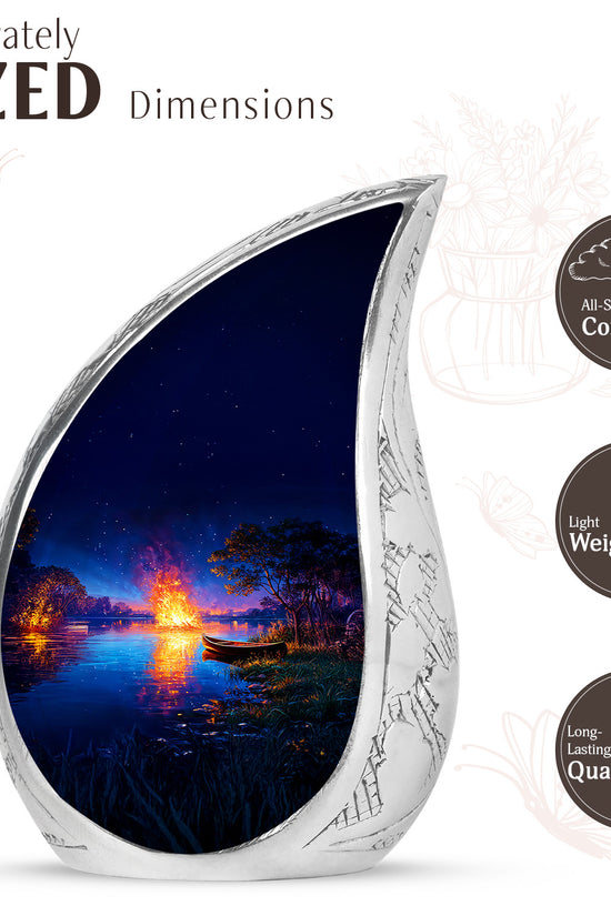 Icy Blue Campfire Cremation Urn angled view of lid and engraved motif - flowing teardrop campfire silhouette on curved aluminum - mini keepsake memorial for portion of cremation ashes