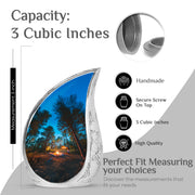 Dusty Blue Campfire Cremation Urn angled view of lid and engraved motif - flowing teardrop campfire silhouette on curved aluminum - mini keepsake memorial for portion of cremation ashes