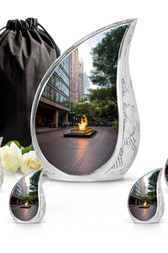 Onyx Black Campfire Cremation Urn side profile showing urn shape - graceful tear-shaped urn with campfire motif - memorial set with one large and four small urns