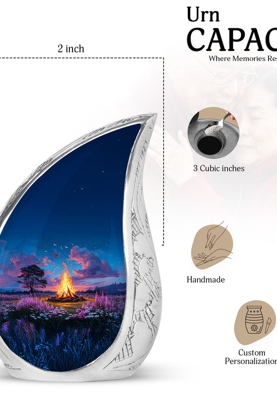 Cornflower Blue Campfire Cremation Urn angled view of lid and engraved motif - smooth teardrop contour featuring campfire art - mini keepsake memorial for portion of cremation ashes