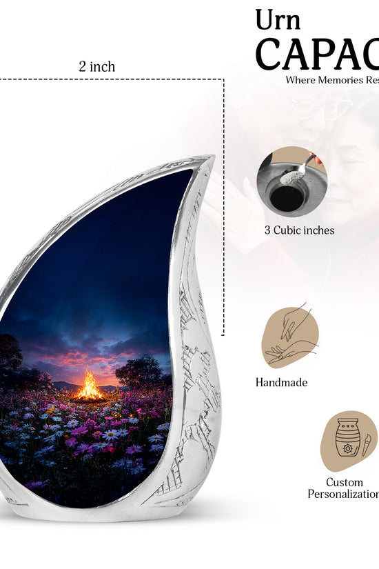 Powder Blue Campfire Cremation Urn angled view of lid and engraved motif - flowing teardrop campfire silhouette on curved aluminum - mini keepsake memorial for portion of cremation ashes
