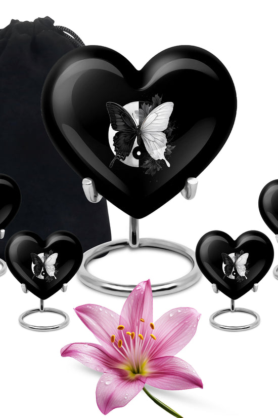Obsidian Black Butterfly Cremation Urn close-up of engraving and surface detail - compassionate heart-butterfly combination with gentle curves - memorial set with one large and four small urns