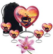 Vintage Pink Bike Cremation Urn close-up of engraving and surface detail - romantic heart urn with bike motif on aluminum - memorial set with one large and four small urns
