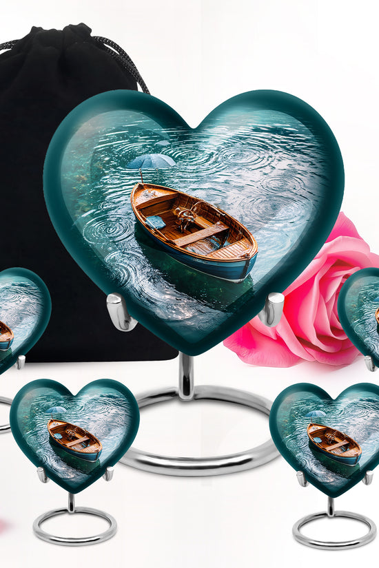 Cool Teal Boat Cremation Urn close-up of engraving and surface detail - heart-shaped boat design symbolizing eternal love - memorial set with one large and four small urns