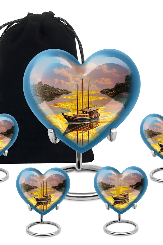 Sunrise Gold Boat Cremation Urn close-up of engraving and surface detail - heart-shaped boat design symbolizing eternal love - memorial set with one large and four small urns