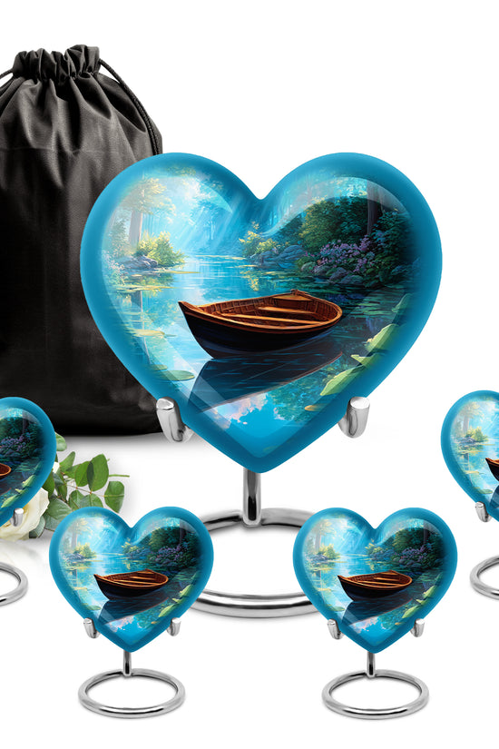 Pastel Blue Boat Cremation Urn close-up of engraving and surface detail - heart-shaped boat design symbolizing eternal love - memorial set with one large and four small urns