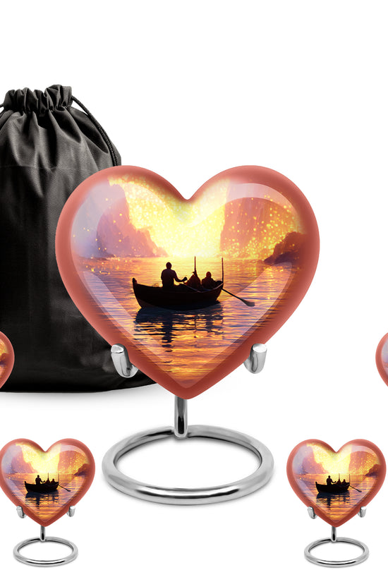 Ruby Red Boat Cremation Urn close-up of engraving and surface detail - romantic heart urn with boat motif on aluminum - memorial set with one large and four small urns