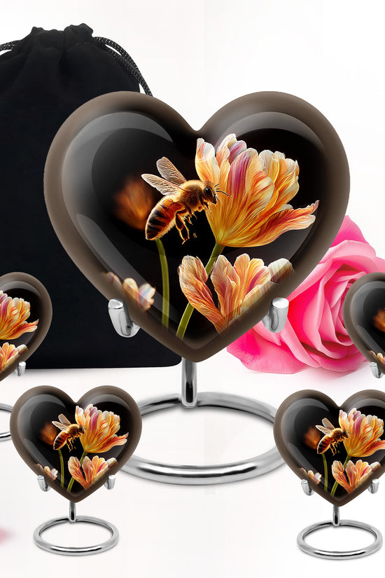 Glossy Black Bee Cremation Urn close-up of engraving and surface detail - heart-shaped bee design symbolizing eternal love - memorial set with one large and four small urns
