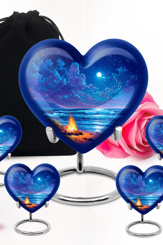 Pastel Blue Campfire Cremation Urn close-up of engraving and surface detail - heart-shaped campfire design symbolizing eternal love - memorial set with one large and four small urns