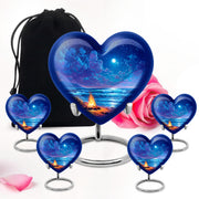 Pastel Blue Campfire Cremation Urn close-up of engraving and surface detail - heart-shaped campfire design symbolizing eternal love - memorial set with one large and four small urns