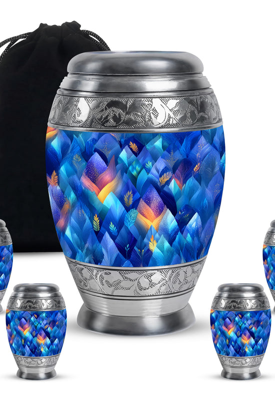 Pastel Blue Blue Cremation Urn detail view - ornate monarch-style blue relief on brushed aluminum - memorial set with one large and four small urns