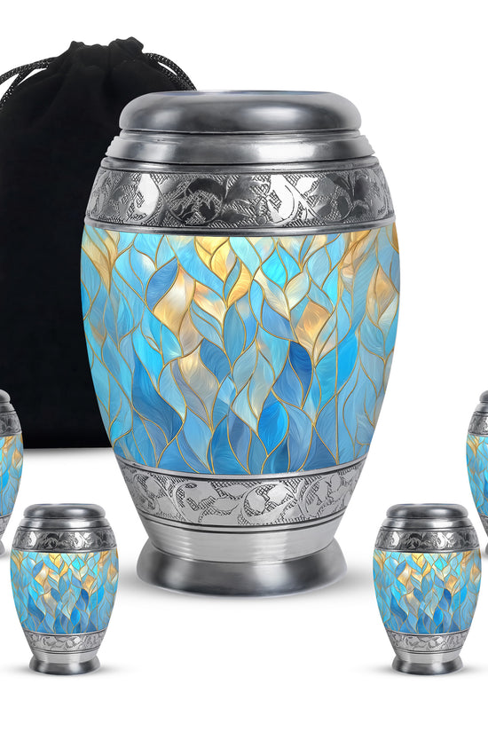 Azure Blue Cremation Urn detail view - ornate monarch-style blue relief on brushed aluminum - memorial set with one large and four small urns