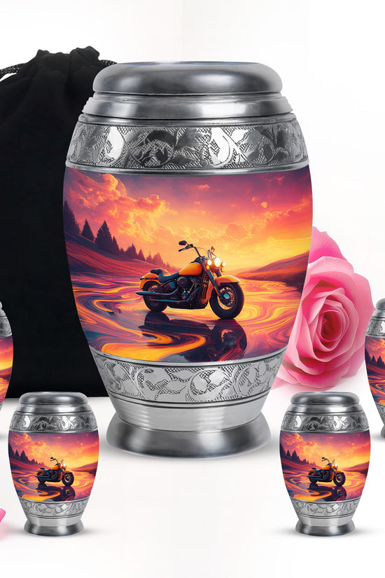 Coral Pink Bike Cremation Urn detail view - ornate monarch-style bike relief on brushed aluminum - memorial set with one large and four small urns