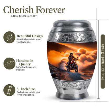 Champagne Gold Bike Cremation Urn lifestyle display on memorial shelf - ornate monarch-style bike relief on brushed aluminum - mini keepsake memorial for portion of cremation ashes