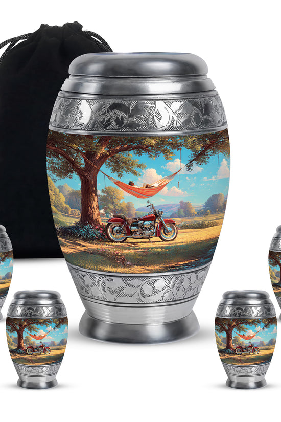 Soft Teal Bike Cremation Urn detail view - ornate monarch-style bike relief on brushed aluminum - memorial set with one large and four small urns