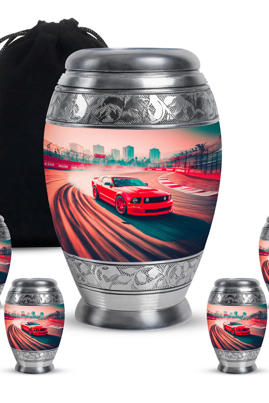 Scarlet Red Car Cremation Urn detail view - royal car engraving with decorative scrollwork - memorial set with one large and four small urns