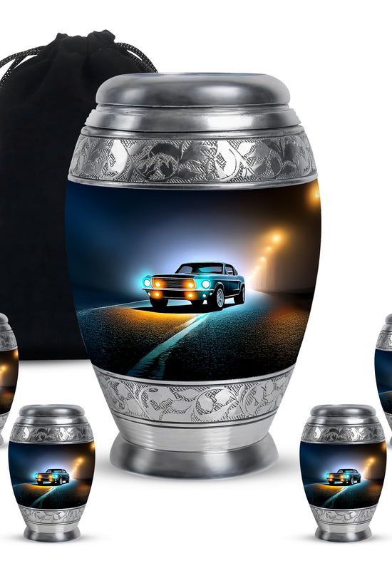 Rich Black Car Cremation Urn detail view - ornate monarch-style car relief on brushed aluminum - memorial set with one large and four small urns