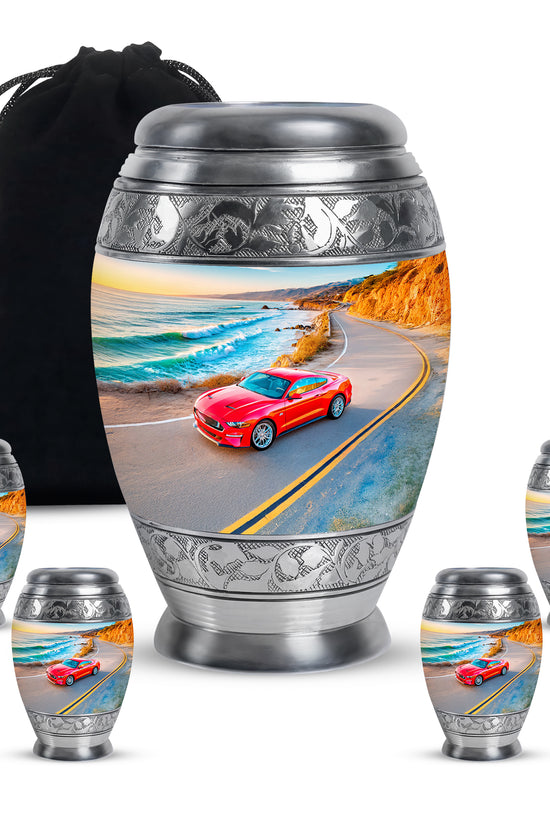 Pastel Blue Car Cremation Urn detail view - ornate monarch-style car relief on brushed aluminum - memorial set with one large and four small urns