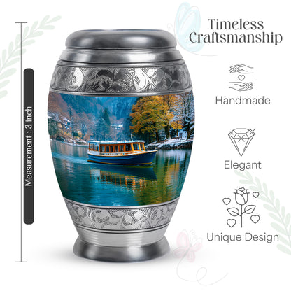 Steel Blue Boat Cremation Urn lifestyle display on memorial shelf - majestic boat pattern with filigree border - mini keepsake memorial for portion of cremation ashes