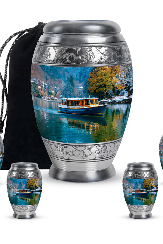 Sky Blue Boat Cremation Urn detail view - ornate monarch-style boat relief on brushed aluminum - memorial set with one large and four small urns