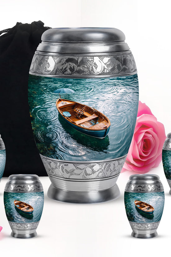 Soft Teal Boat Cremation Urn detail view - regal boat design with crown-inspired accents - memorial set with one large and four small urns