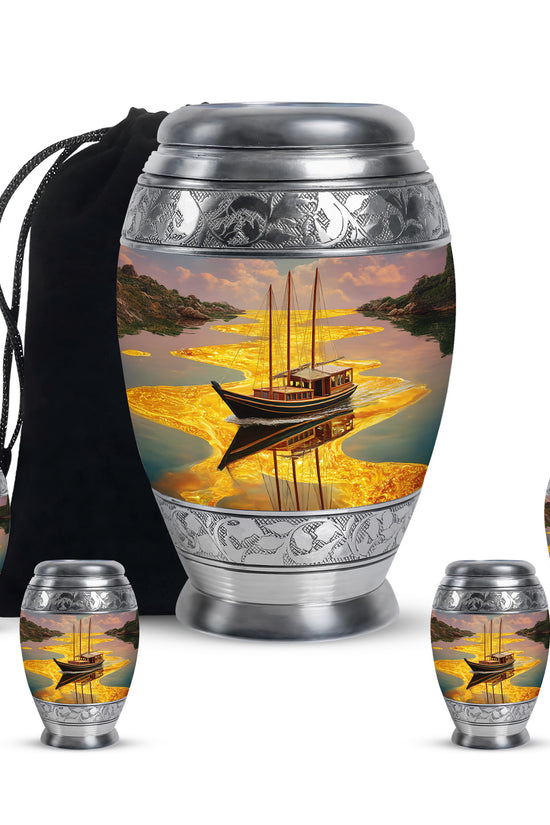 Antique Gold Boat Cremation Urn detail view - ornate monarch-style boat relief on brushed aluminum - memorial set with one large and four small urns