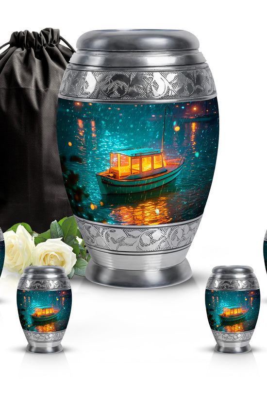 Cool Teal Boat Cremation Urn detail view - ornate monarch-style boat relief on brushed aluminum - memorial set with one large and four small urns