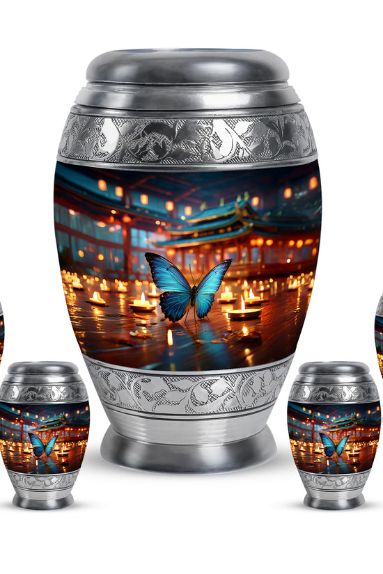 Icy Blue Butterfly Cremation Urn detail view - ornate monarch-style butterfly relief on brushed aluminum - memorial set with one large and four small urns