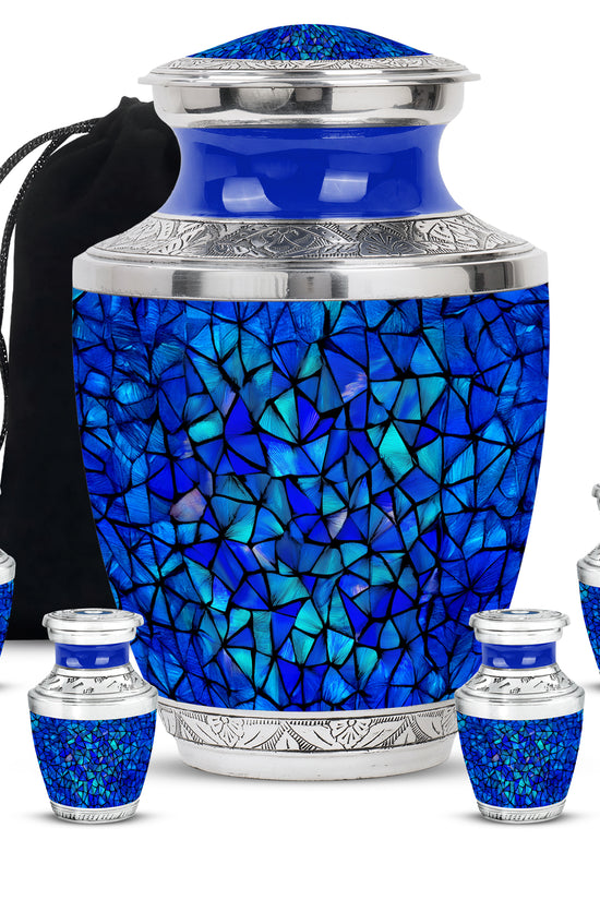 Dusty Blue Blue Cremation Urn lifestyle display on memorial shelf - modern art-inspired blue motif on sleek aluminum - memorial set with one large and four small urns