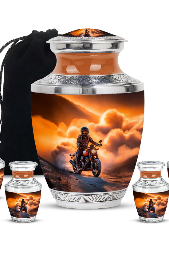 Burnished Gold Bike Cremation Urn lifestyle display on memorial shelf - stylized abstract bike pattern with bold lines - memorial set with one large and four small urns
