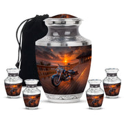 Midnight Black Bike Cremation Urn lifestyle display on memorial shelf - stylized abstract bike pattern with bold lines - memorial set with one large and four small urns