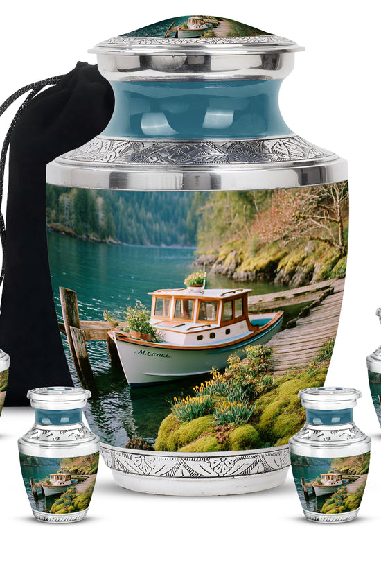 Sea Green Teal Boat Cremation Urn lifestyle display on memorial shelf - modern art-inspired boat motif on sleek aluminum - memorial set with one large and four small urns
