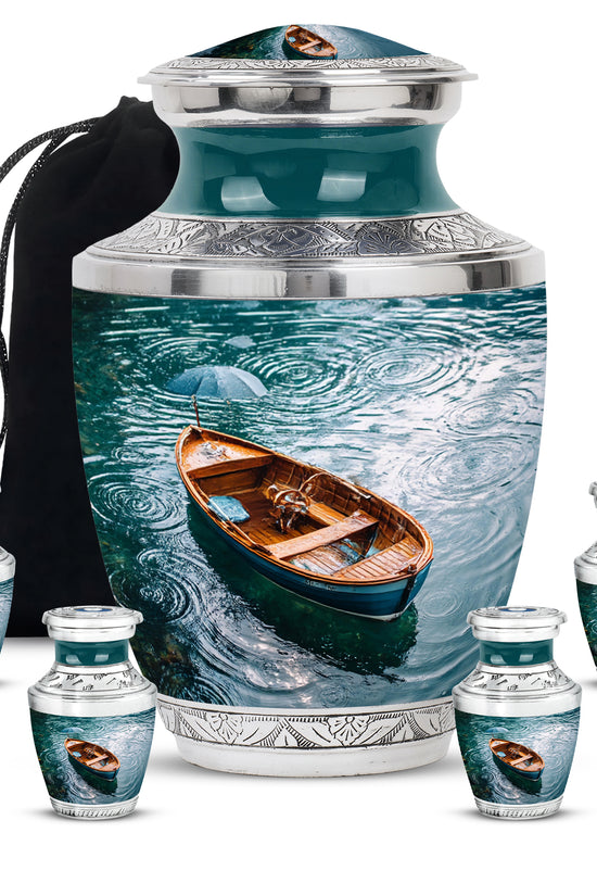 Ocean Teal Boat Cremation Urn lifestyle display on memorial shelf - modern art-inspired boat motif on sleek aluminum - memorial set with one large and four small urns