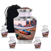 Polished Silver Car Cremation Urn lifestyle display on memorial shelf - stylized abstract car pattern with bold lines - memorial set with one large and four small urns