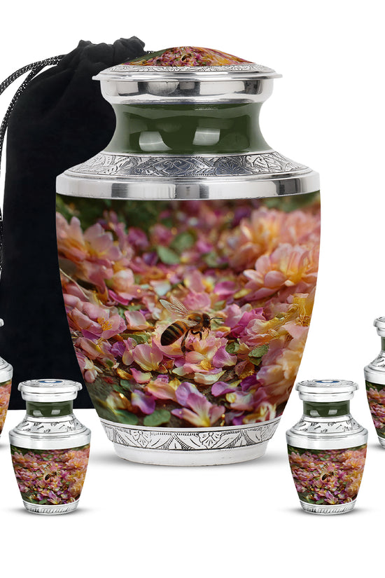 Warm Gold Bee Cremation Urn lifestyle display on memorial shelf - stylized abstract bee pattern with bold lines - memorial set with one large and four small urns