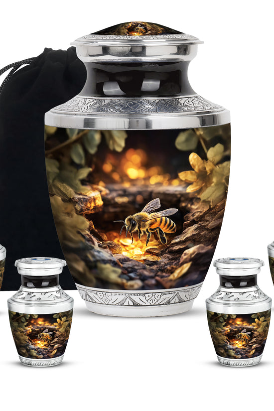 Matte Gold Bee Cremation Urn lifestyle display on memorial shelf - stylized abstract bee pattern with bold lines - memorial set with one large and four small urns