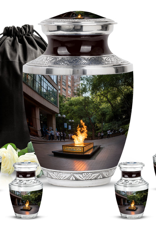 Midnight Black Campfire Cremation Urn lifestyle display on memorial shelf - stylized abstract campfire pattern with bold lines - memorial set with one large and four small urns