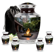 Midnight Black Campfire Cremation Urn lifestyle display on memorial shelf - stylized abstract campfire pattern with bold lines - memorial set with one large and four small urns