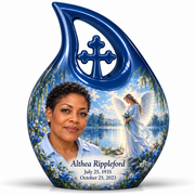 10 inch large Urn, Cross Drop angel beside quiet blue water memorial urn and Althea Rippleford photo and dates.
