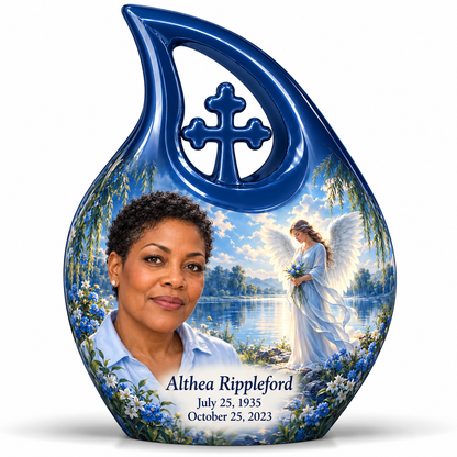 10 inch large Urn, Cross Drop angel beside quiet blue water memorial urn and Althea Rippleford photo and dates.