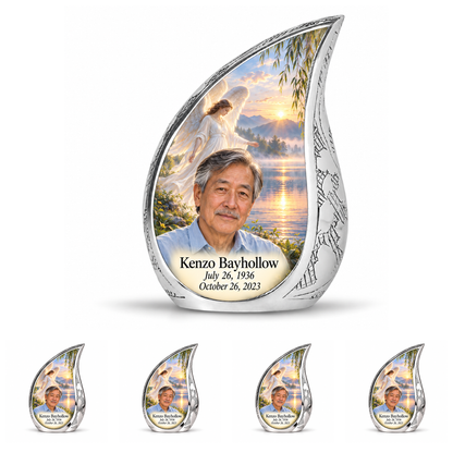 10 inch large Urn with 4 Keepsake 3 Inch Urns, Curved Drop angel beside quiet blue water memorial urn and Kenzo Bayhollow photo and dates.