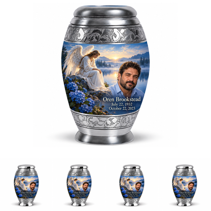 10 inch large Urn with 4 Keepsake 3 Inch Urns, Monar angel beside quiet blue water memorial urn and Oren Brookstead photo and dates.