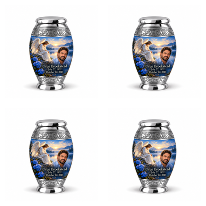4 Keepsake 3 inch Urns, Monar angel beside quiet blue water memorial urn and Oren Brookstead photo and dates.