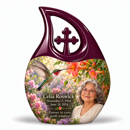 Hummingbird 01 Cross Drop, 10 inch large Urn: glossy mulberry-plum loop above a ruby-throated hummingbird, coral trumpet flowers and rose-lavender garden; fictional Celia Roswick portrait, name and full dates.