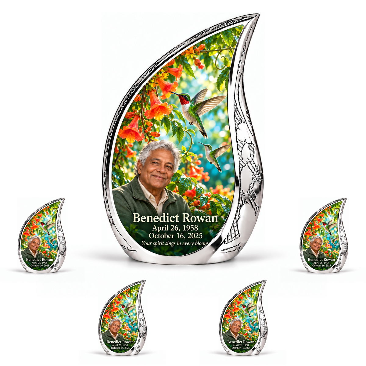 Hummingbird 01 Curved Drop, 10 inch large Urn with 4 Keepsake 3 Inch Urns: engraved silver Curved Drop surrounding two hummingbirds, orange trumpet vine and turquoise garden; fictional Benedict Rowan portrait, name and full dates.