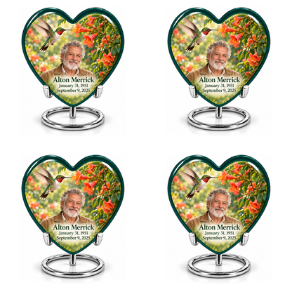Hummingbird 01 set of four identical Heart keepsakes in two rows, each with a hovering ruby-throated bird, orange trumpet vine, fictional Alton Merrick portrait and full dates on silver ring stands.